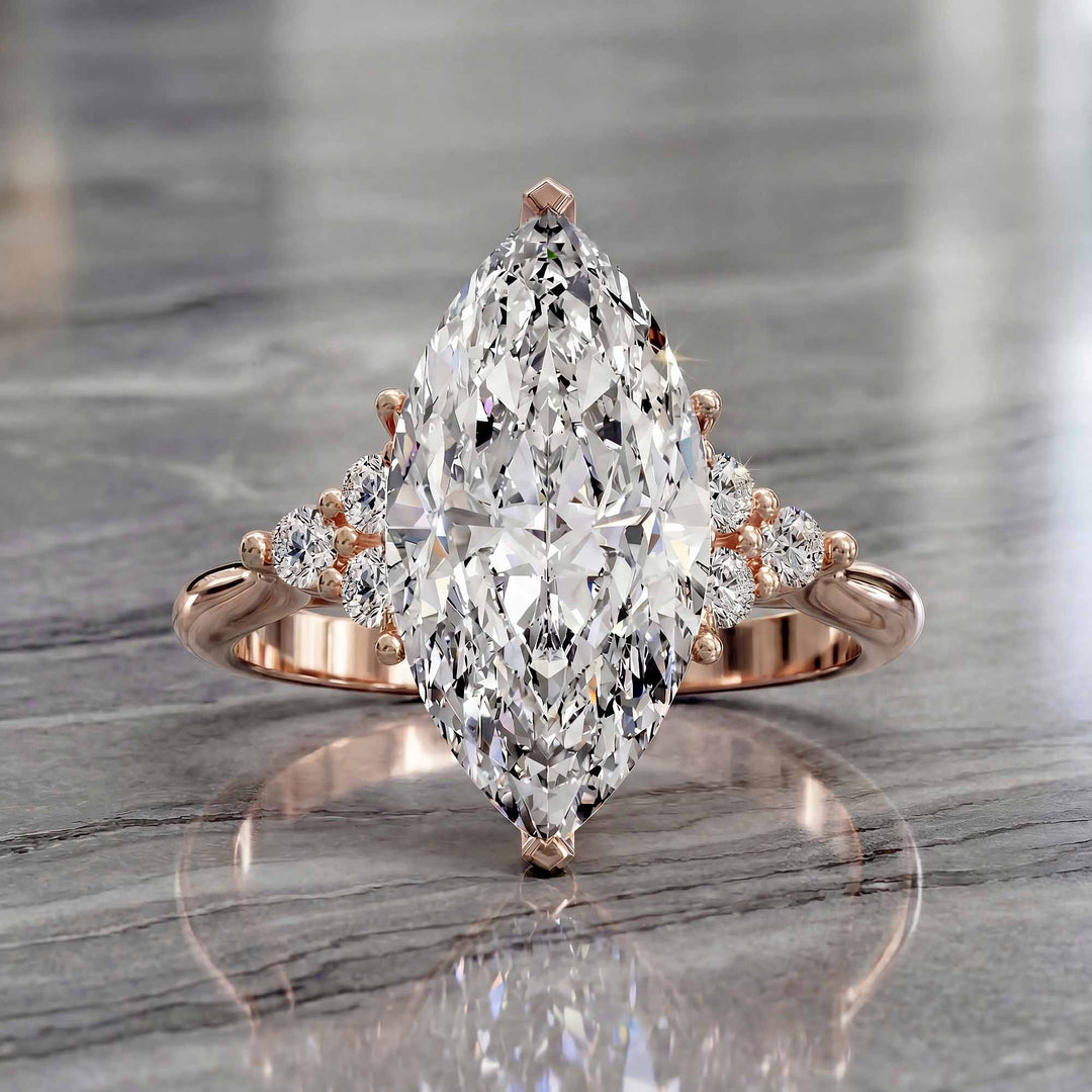Marquise diamond engagement ring with clustered side diamonds.
