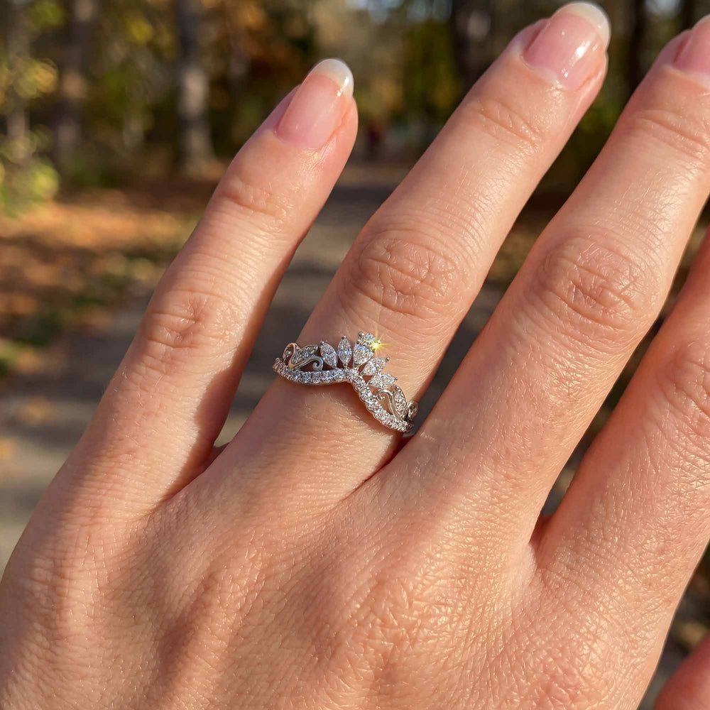 Marquise-style curved lab-grown diamond wedding band with round accent stones on display.
