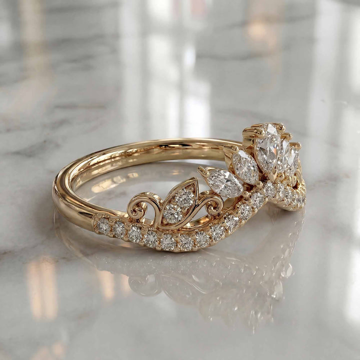 Marquise-style curved lab-grown diamond wedding band with round accent stones on display.