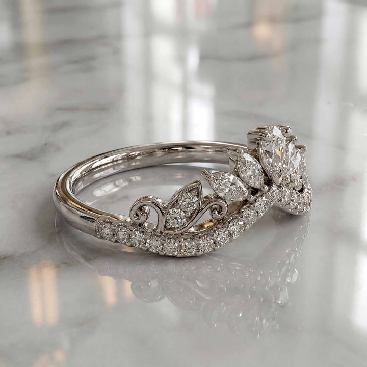 Marquise-style curved lab-grown diamond wedding band with round accent stones on display.