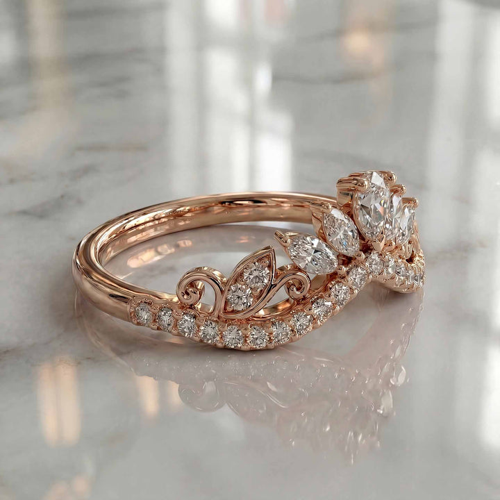 Marquise-style curved lab-grown diamond wedding band with round accent stones on display.