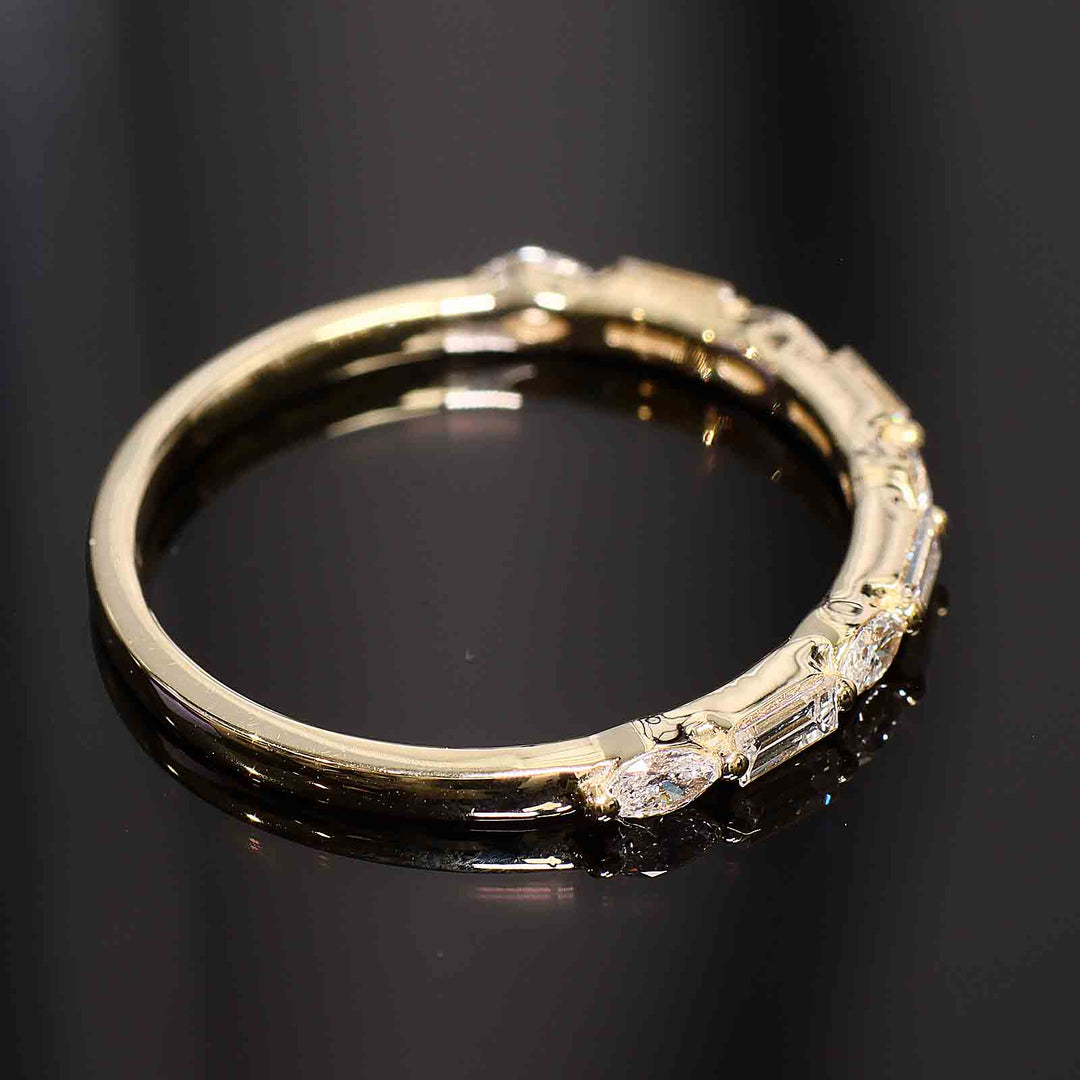 A wedding band with lab-grown marquise and baguette diamonds set with shared prongs, floating elegantly on the band.