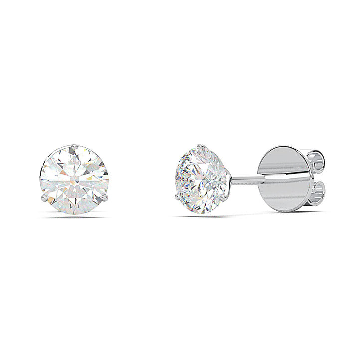 0.6 carat round diamond martini stud earrings with three-prong setting.