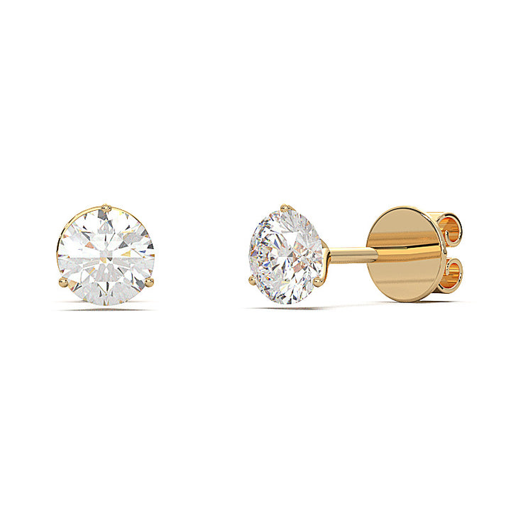 0.6 carat round diamond martini stud earrings with three-prong setting.