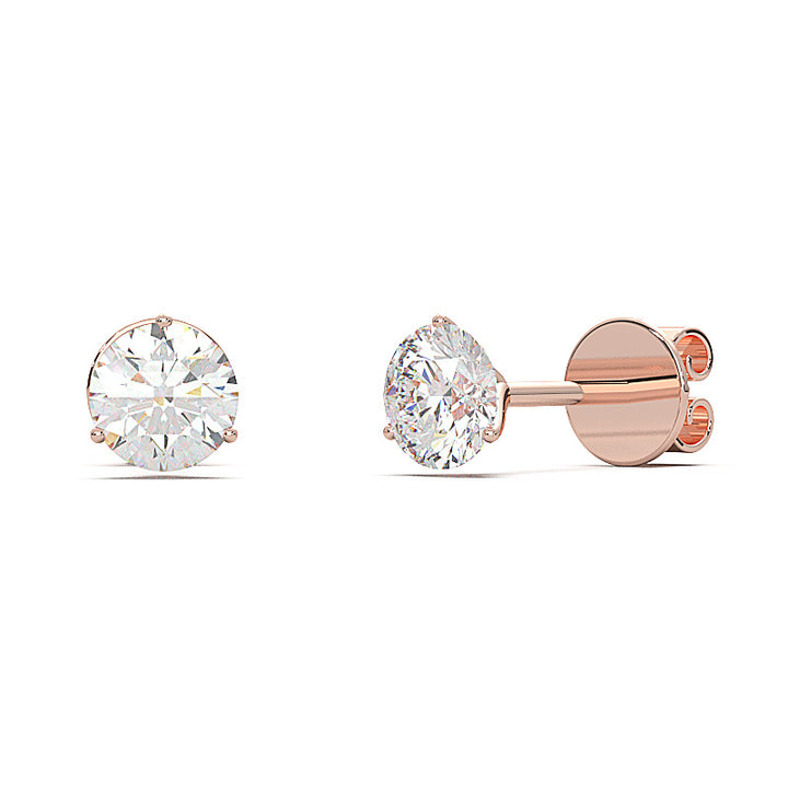 0.6 carat round diamond martini stud earrings with three-prong setting.