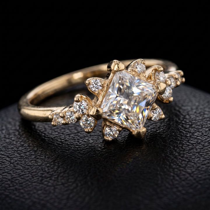Moissanite engagement ring with 0.90CT center stone, accent stones, set in 14K gold.