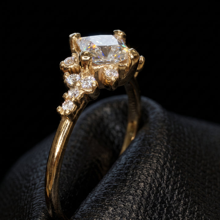Moissanite engagement ring with 0.90CT center stone, accent stones, set in 14K gold.