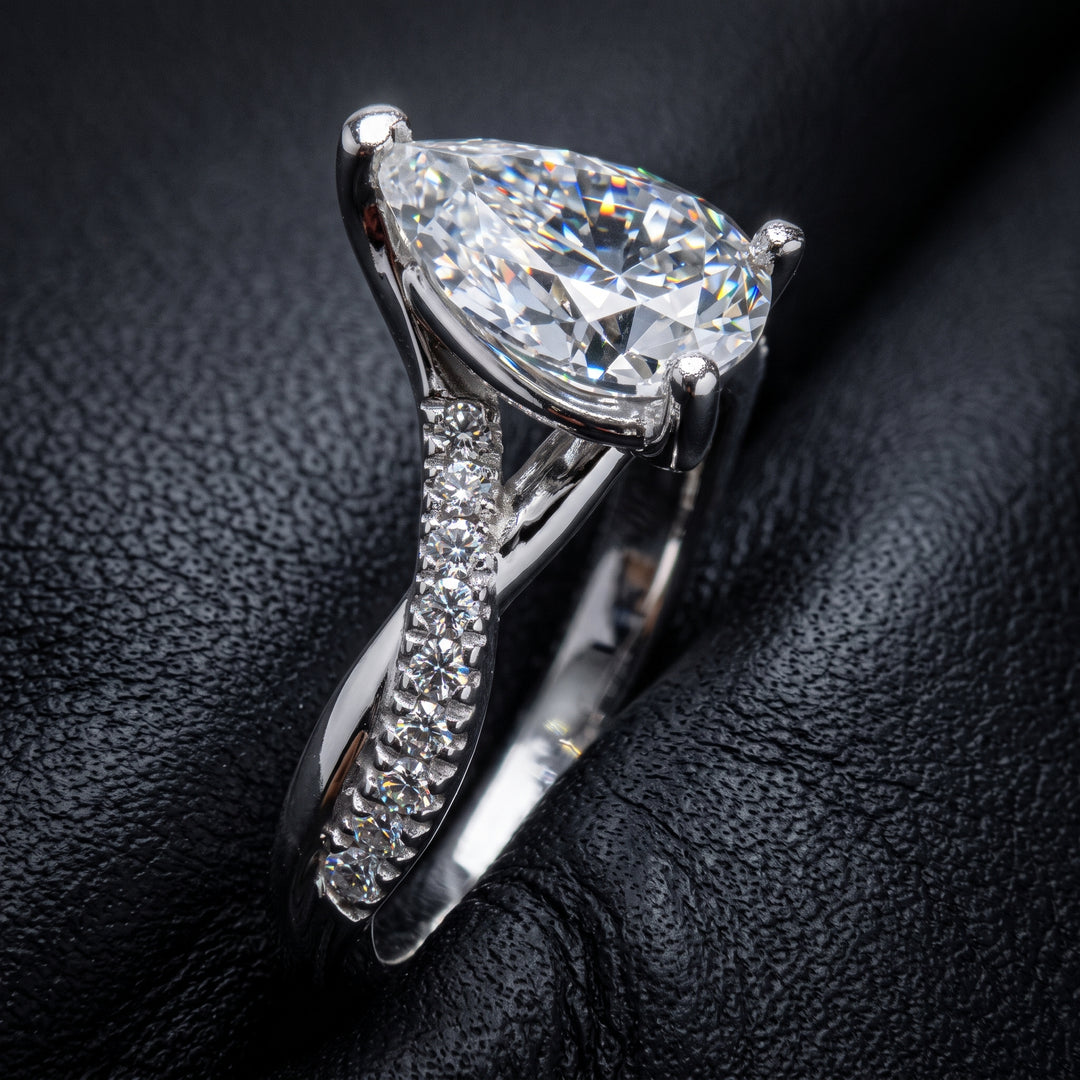 Moissanite pear-shaped engagement ring with 1.20CT center stone, accent moissanite, set in 14K gold.