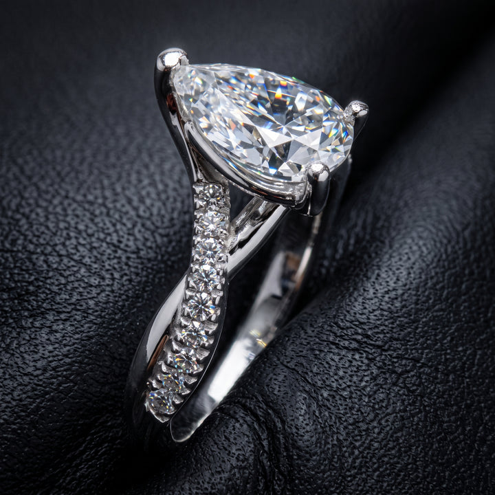 Moissanite pear-shaped engagement ring with 1.20CT center stone, accent moissanite, set in 14K gold.
