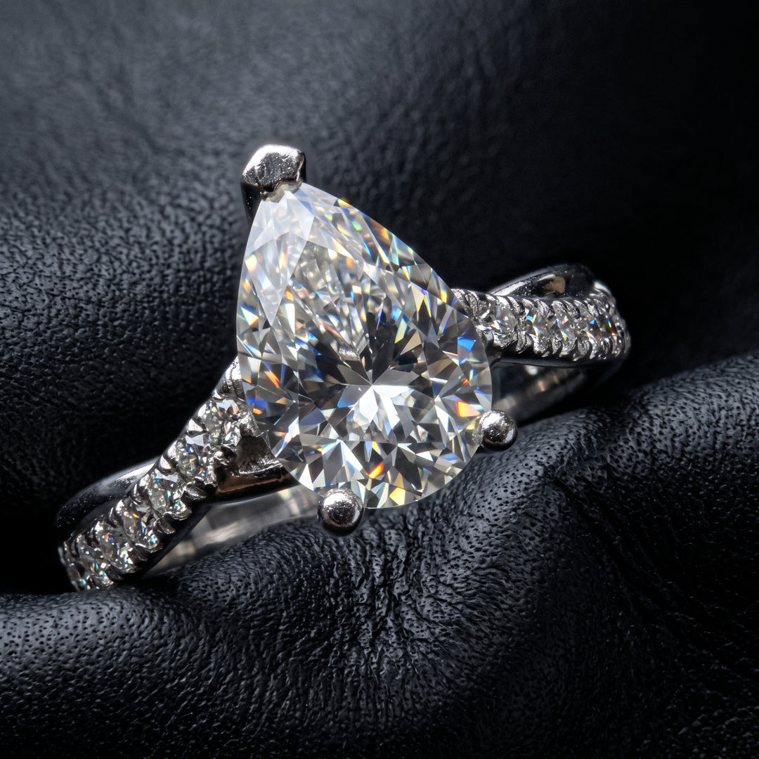 Moissanite pear-shaped engagement ring with 1.20CT center stone, accent moissanite, set in 14K gold.