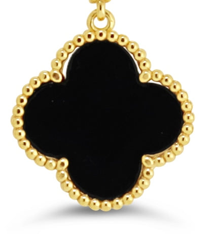 Gold and black onyx four-leaf clover earring with beaded gold detailing.