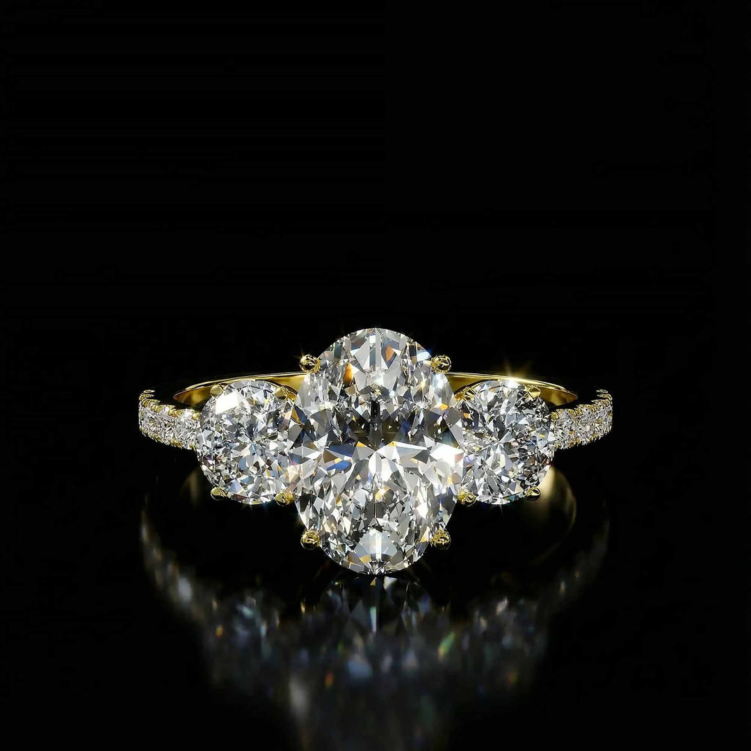 Oval diamond three stone engagement ring with round side stones and pavé band on display.
