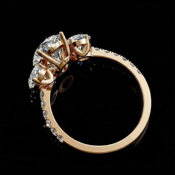 Oval diamond three stone engagement ring with round side stones and pavé band on display.