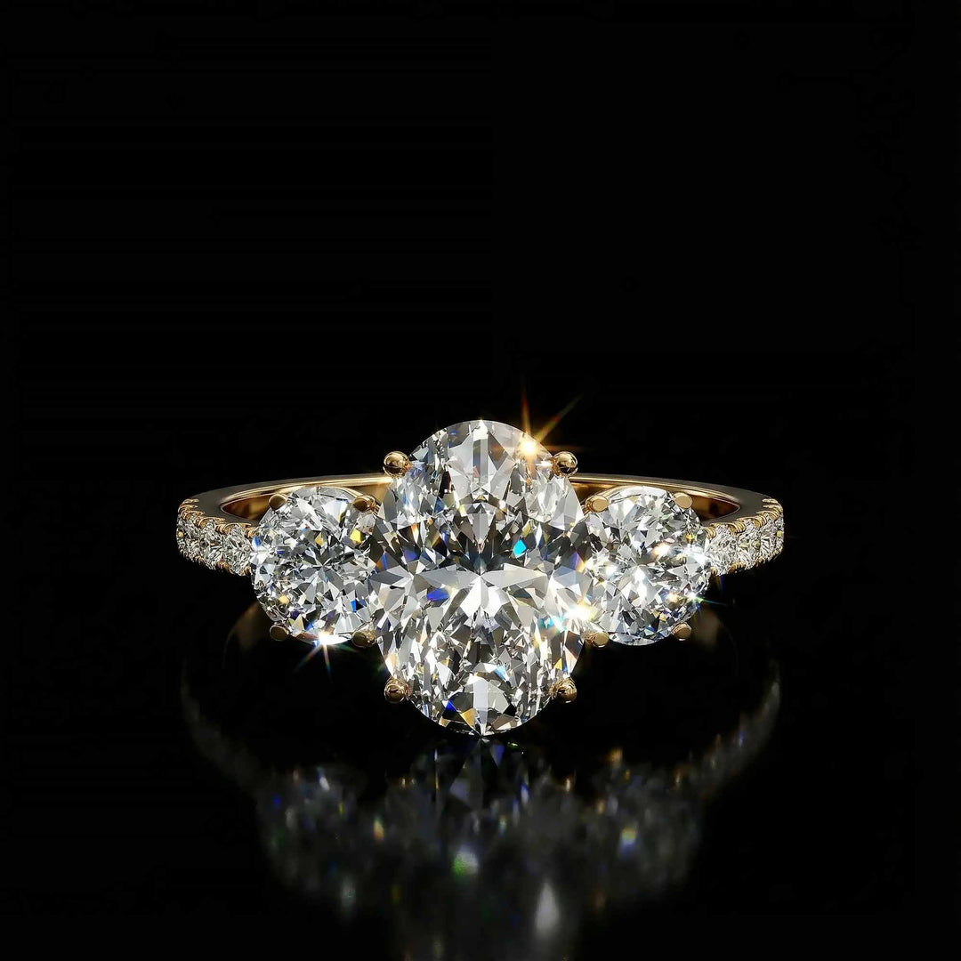 Oval diamond three stone engagement ring with round side stones and pavé band on display.
