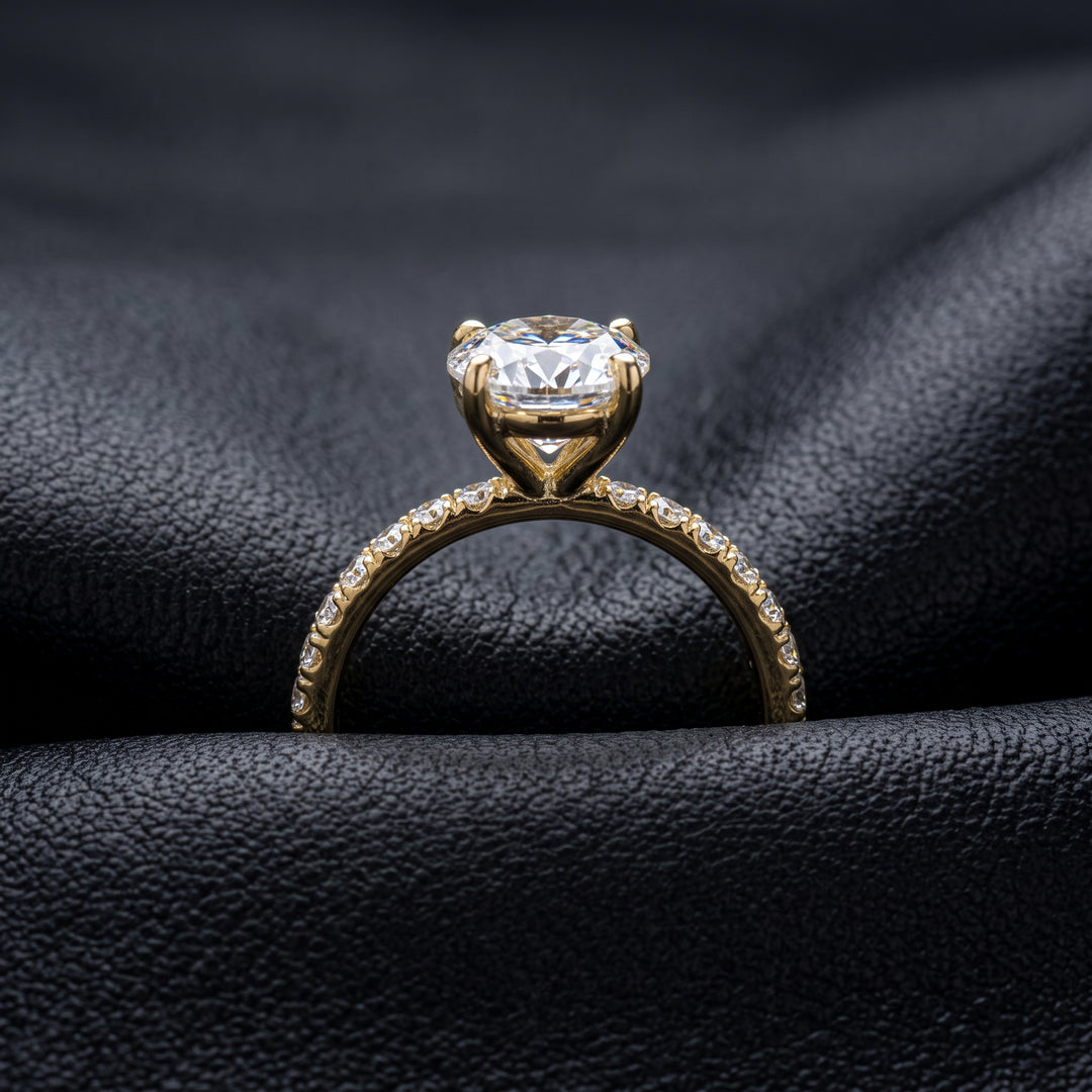 2.5 Ct oval moissanite engagement ring with pave band in 14K gold.