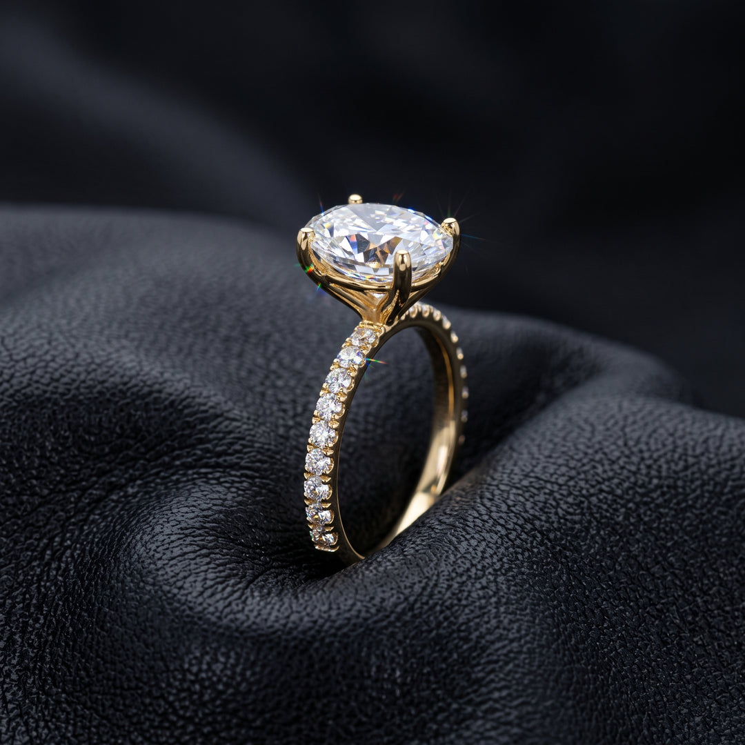 2.5 Ct oval moissanite engagement ring with pave band in 14K gold.