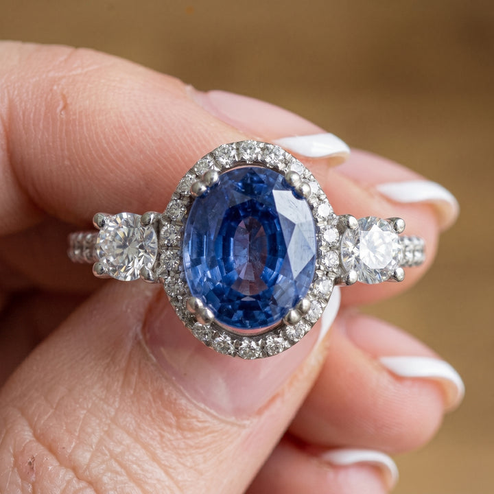 Stunning 14K Gold Oval Blue Sapphire Ring with Halo and Side Stones