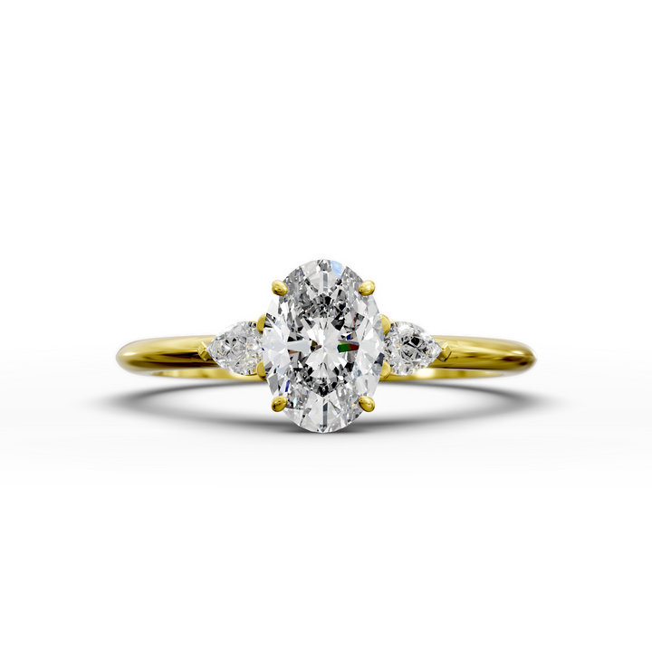 Oval three stone engagement ring with pear side diamonds on a slim band.