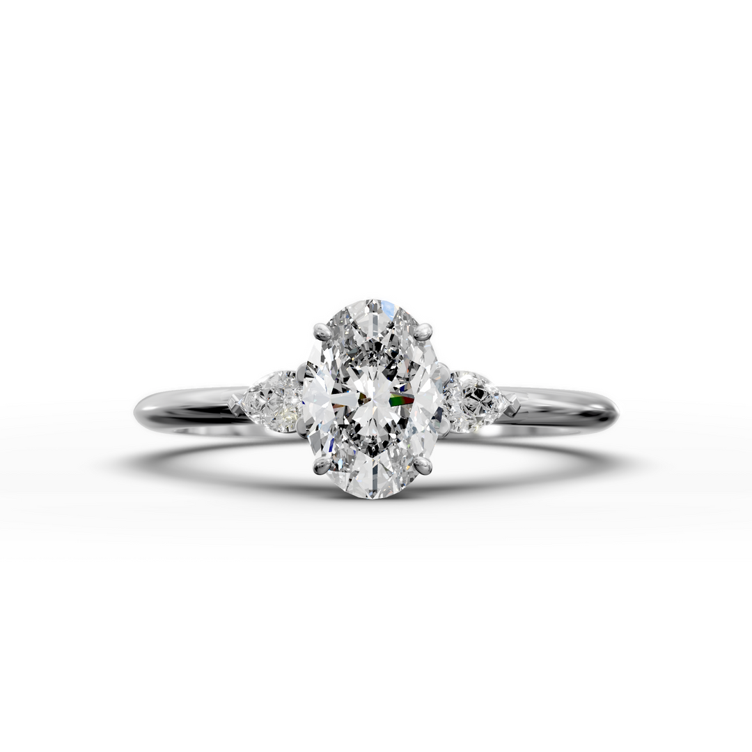 Oval three stone engagement ring with pear side diamonds on a slim band.