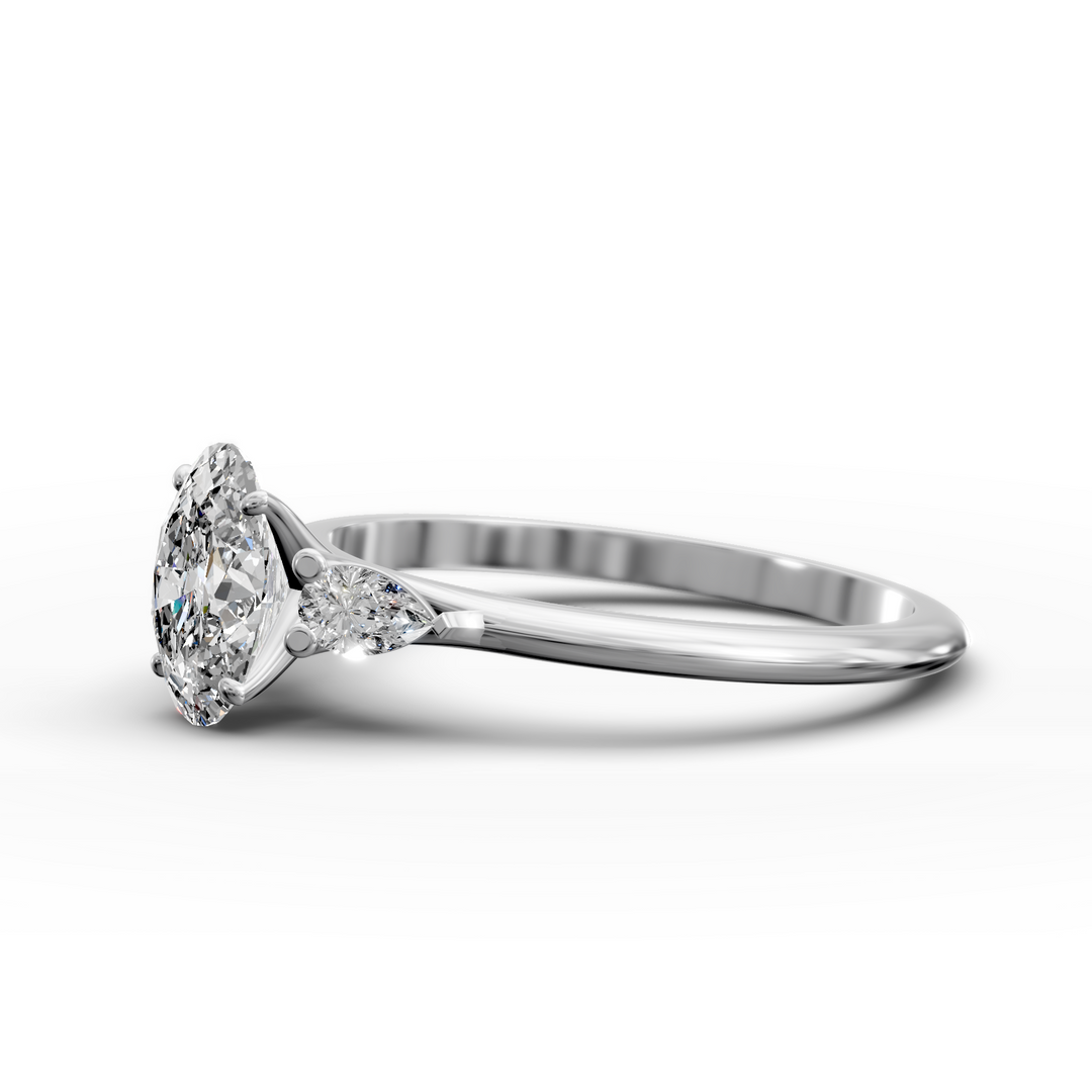 Oval three stone engagement ring with pear side diamonds on a slim band.