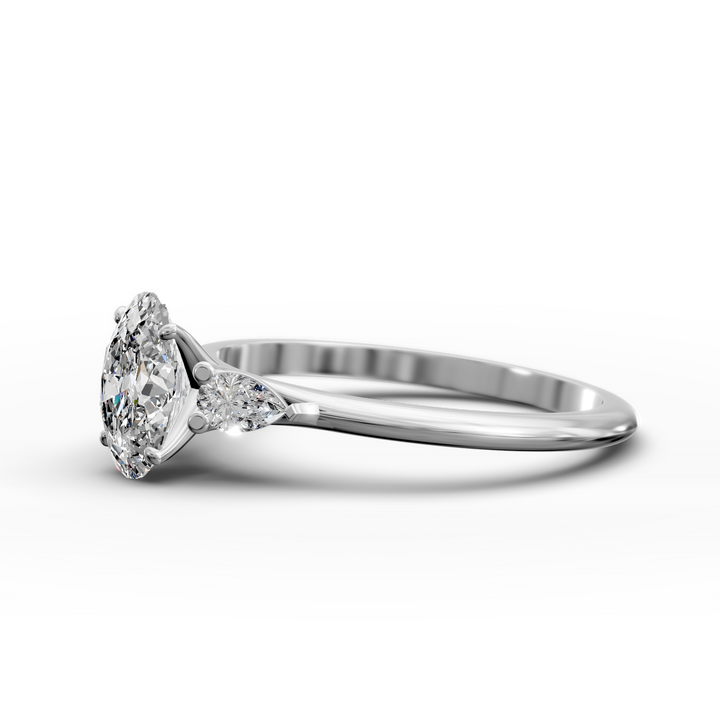 Oval three stone engagement ring with pear side diamonds on a slim band.