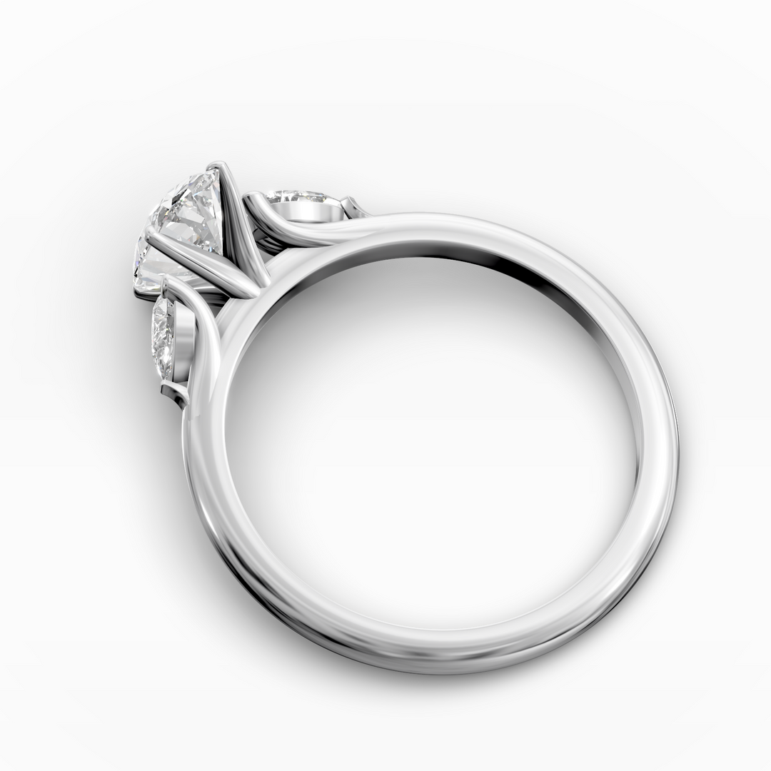 Oval three stone engagement ring with pear side diamonds on a slim band.
