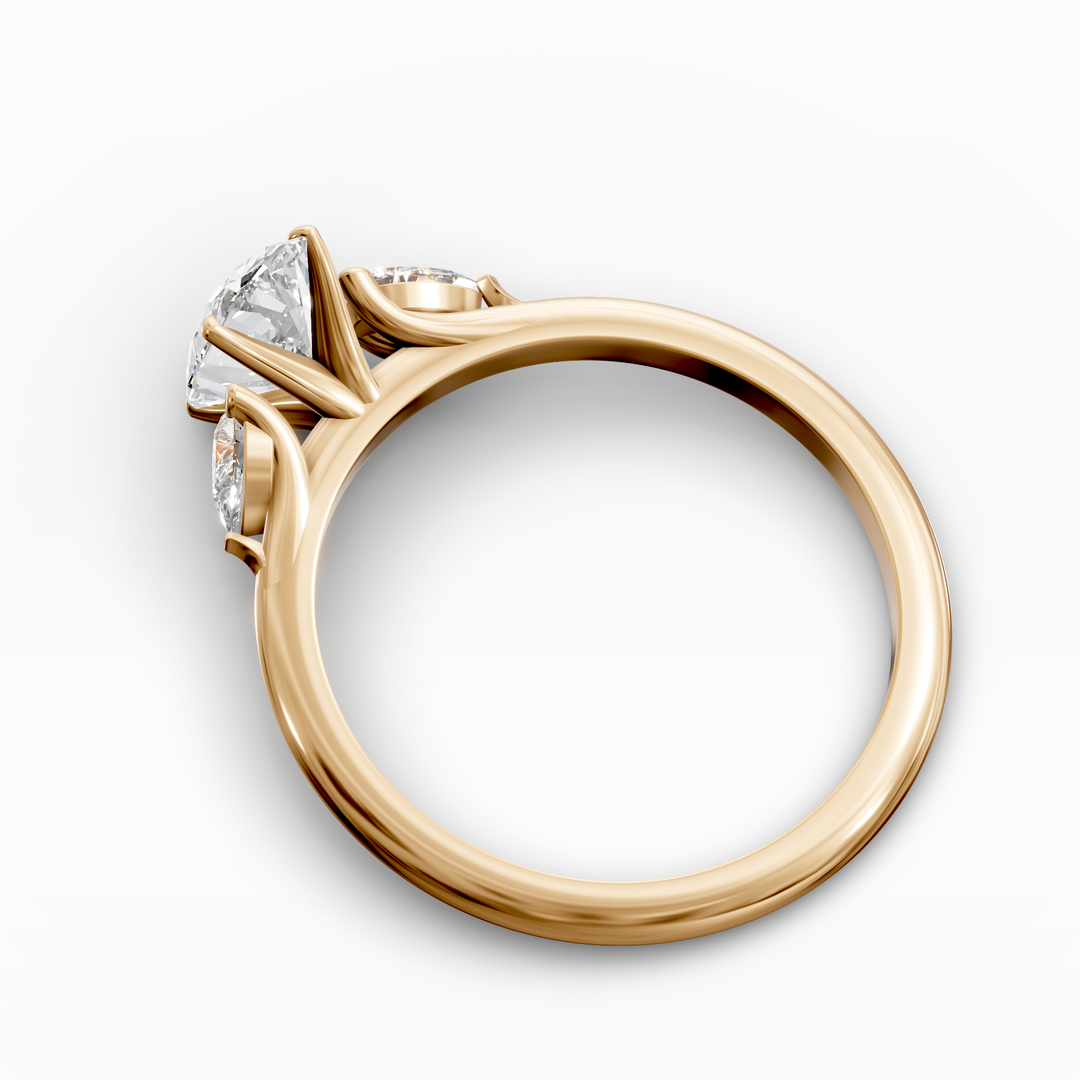 Oval three stone engagement ring with pear side diamonds on a slim band.