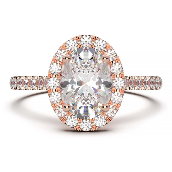 Oval lab-grown diamond halo engagement ring with pavé diamonds on the band in a cathedral setting.