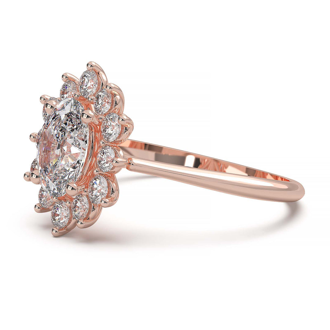 Oval lab-grown diamond ring with a sunburst halo of small diamonds in a low-profile setting.