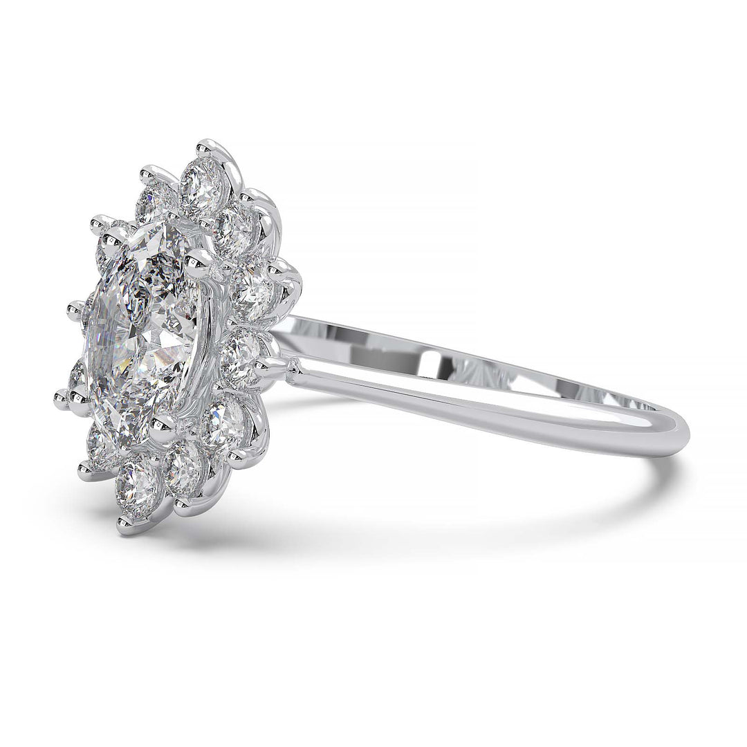 Oval lab-grown diamond ring with a sunburst halo of small diamonds in a low-profile setting.