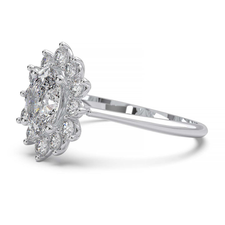 Oval lab-grown diamond ring with a sunburst halo of small diamonds in a low-profile setting.