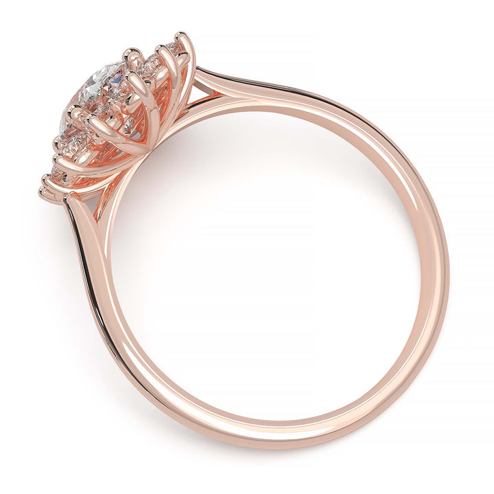 Oval lab-grown diamond ring with a sunburst halo of small diamonds in a low-profile setting.