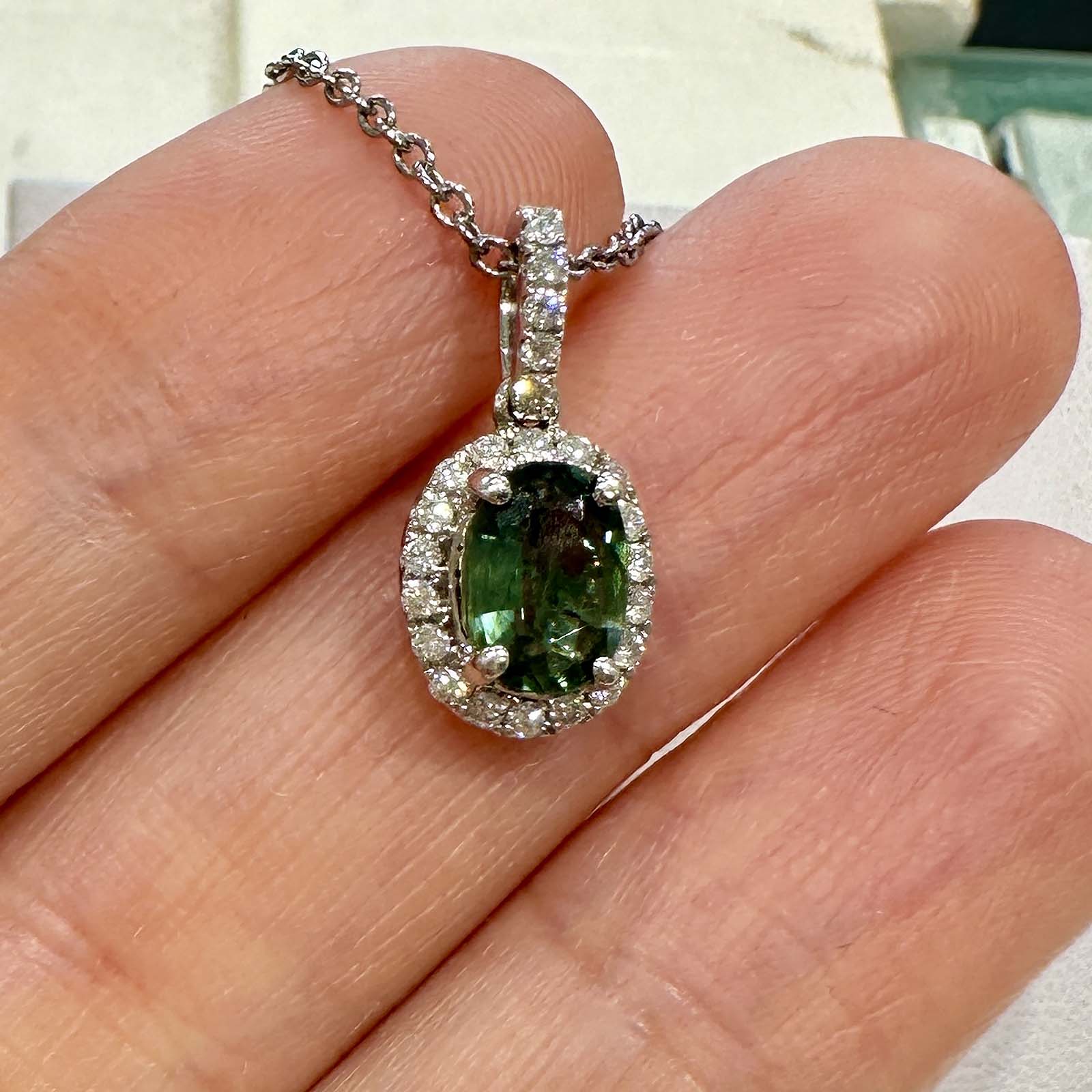 Natural oval green sapphire pendant with diamond halo in 14k white gold, 1.06ct sapphire with 0.23ct diamonds.