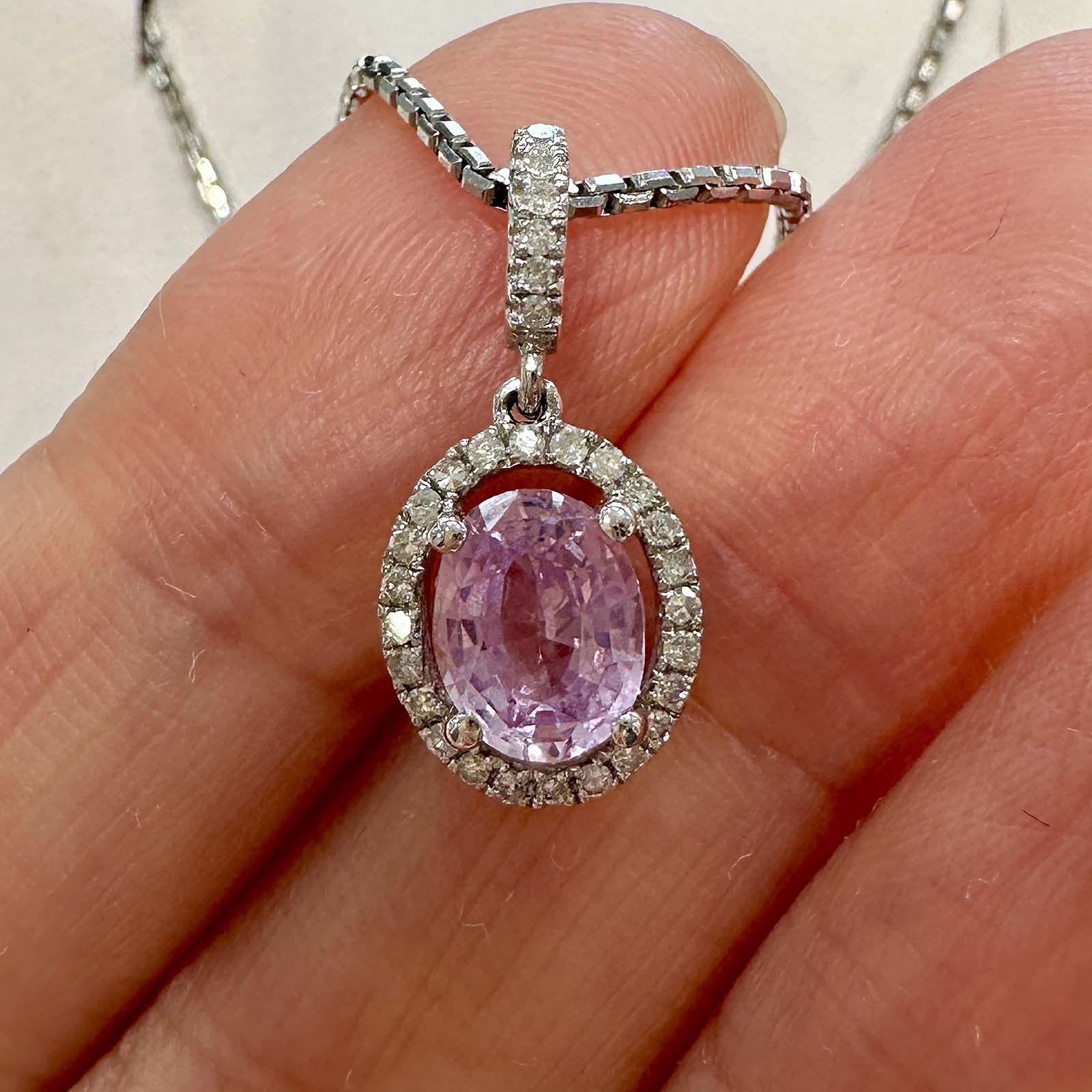 Unique light purple sapphire pendant with diamond halo in 14k white gold.