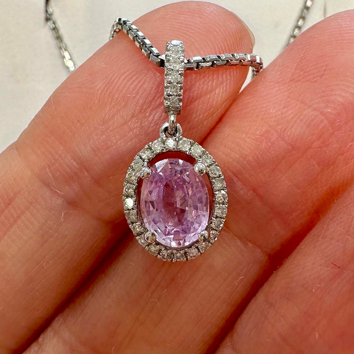 Unique light purple sapphire pendant with diamond halo in 14k white gold.