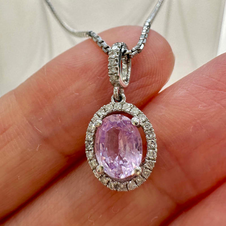 Unique light purple sapphire pendant with diamond halo in 14k white gold.