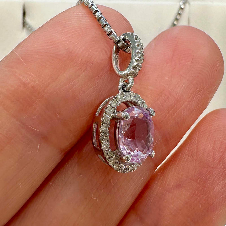 Unique light purple sapphire pendant with diamond halo in 14k white gold.