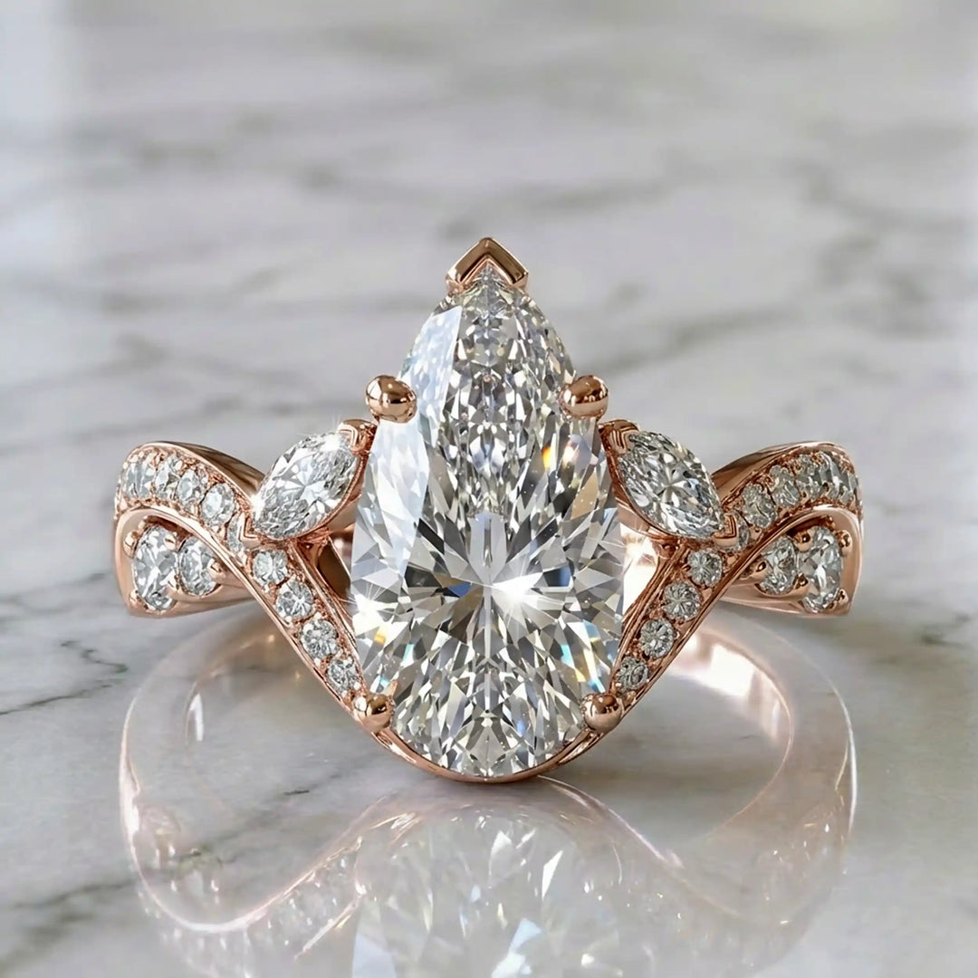 3 carat pear lab diamond twisted three-stone engagement ring displayed on marble surface.
