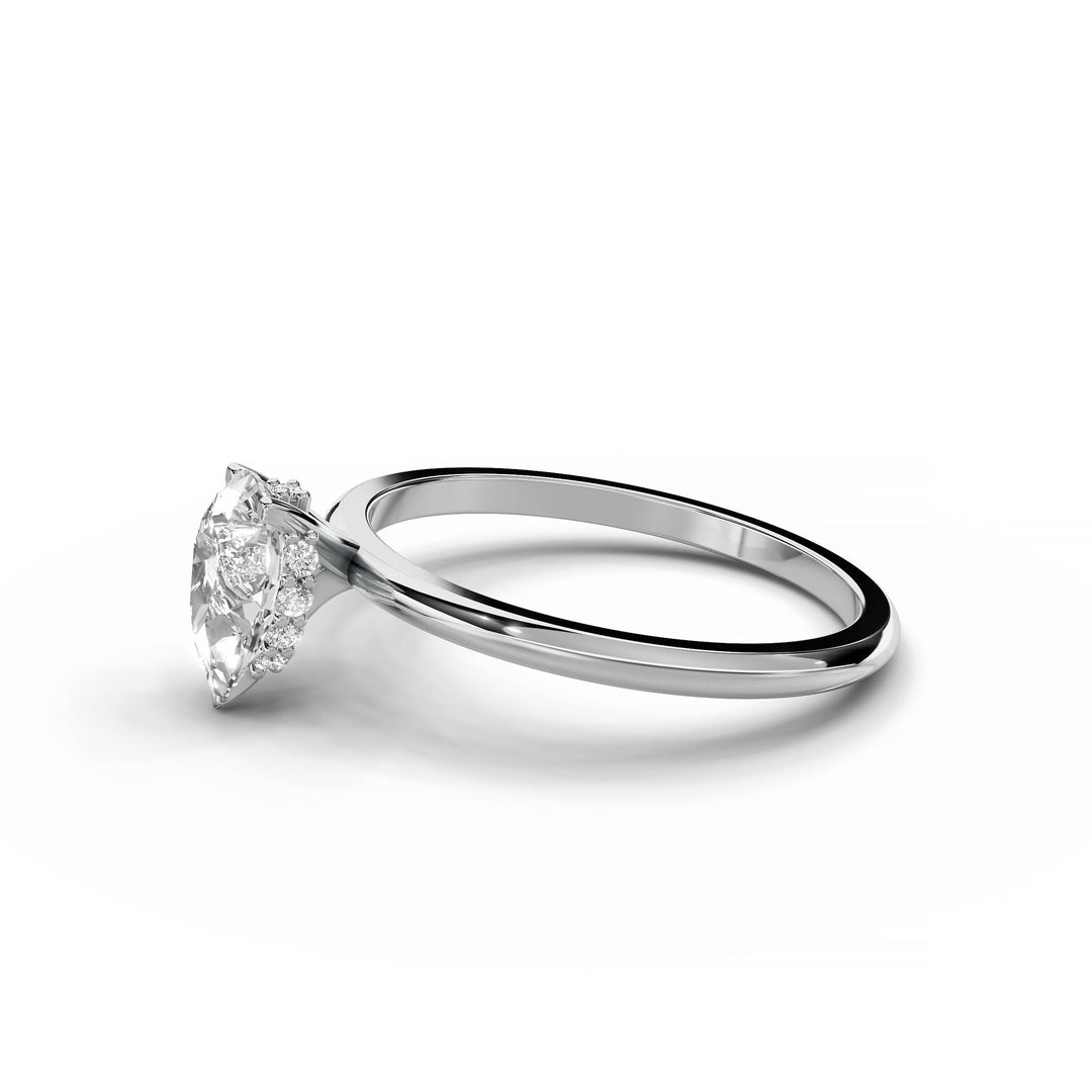 Pear-shaped diamond engagement ring in white gold with hidden halo design.
