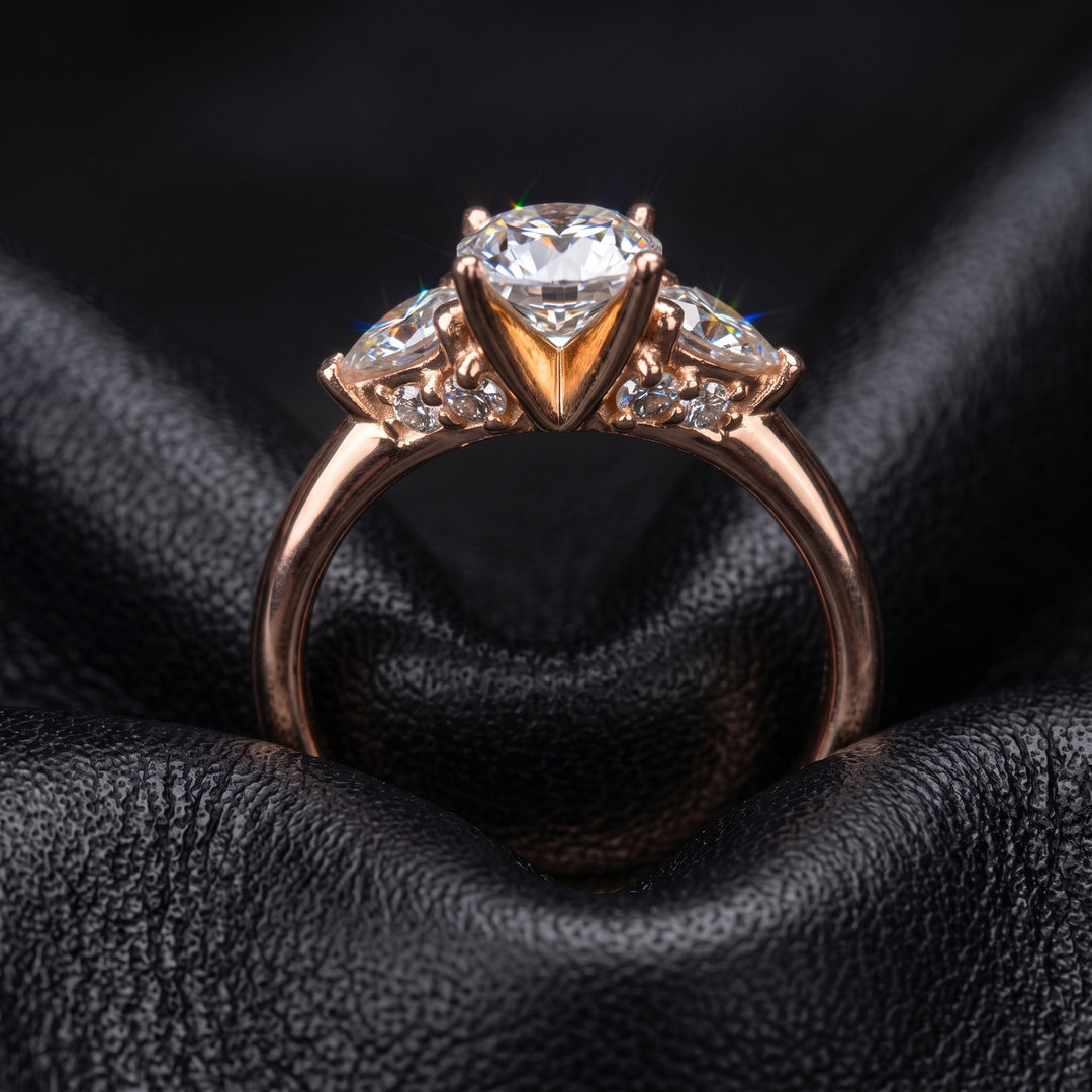 Radiant-cut moissanite ring with trillion side stones set in 14K yellow gold.