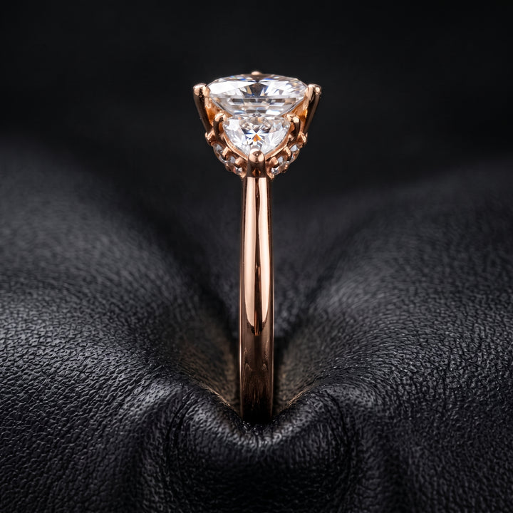 Radiant-cut moissanite ring with trillion side stones set in 14K yellow gold.