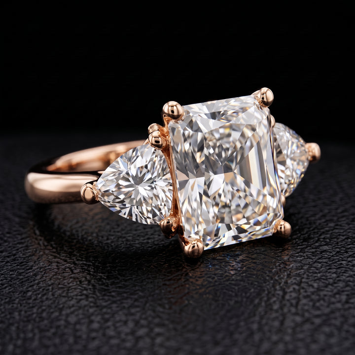 Radiant-cut moissanite ring with trillion side stones set in 14K yellow gold.