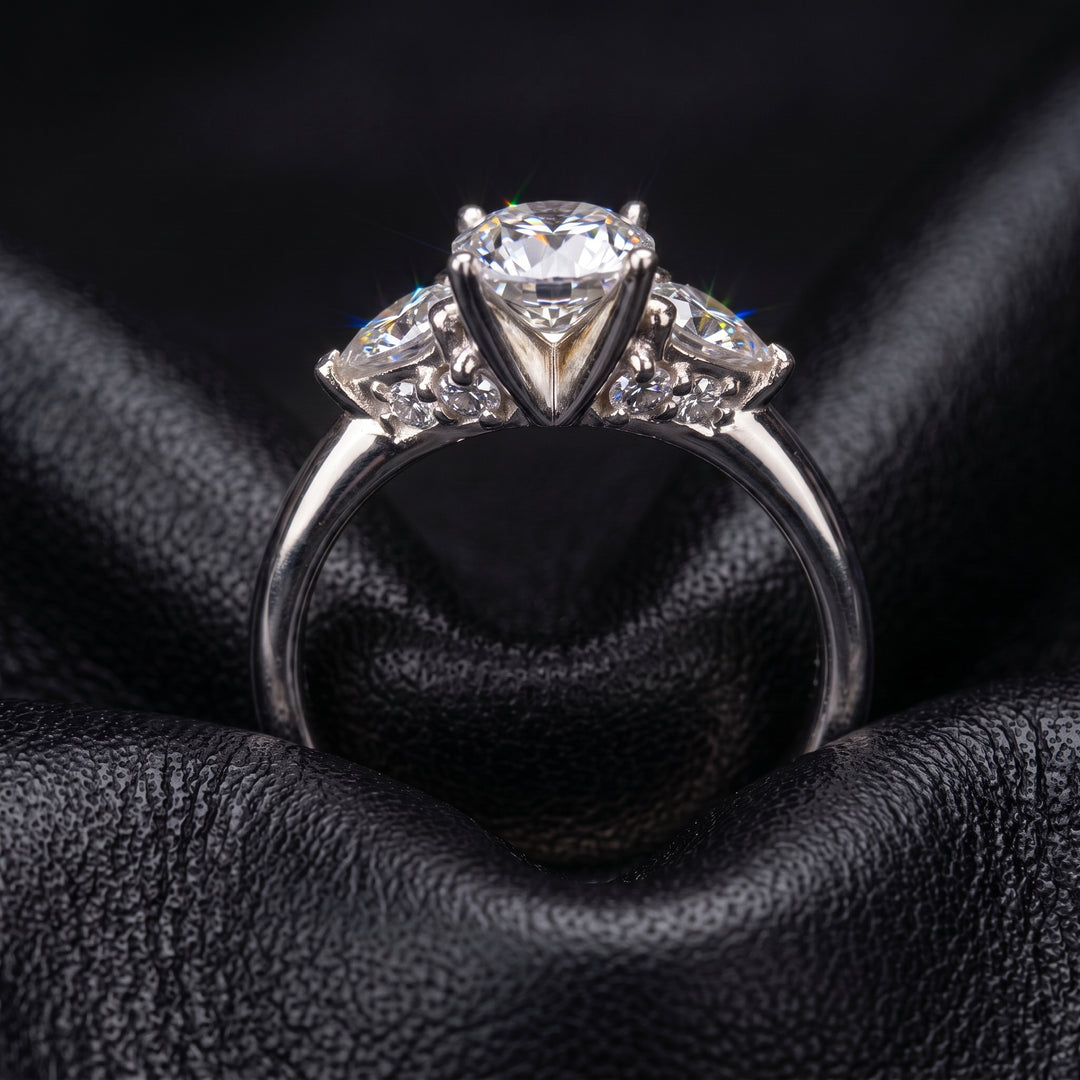 Radiant-cut moissanite ring with trillion side stones set in 14K yellow gold.