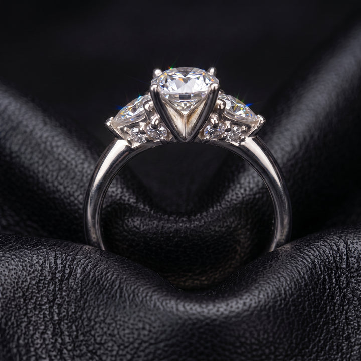 Radiant-cut moissanite ring with trillion side stones set in 14K yellow gold.