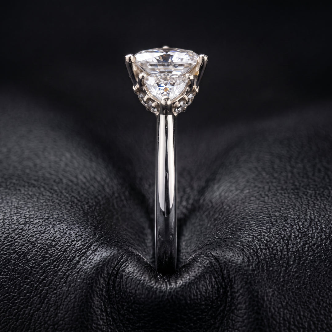 Radiant-cut moissanite ring with trillion side stones set in 14K yellow gold.