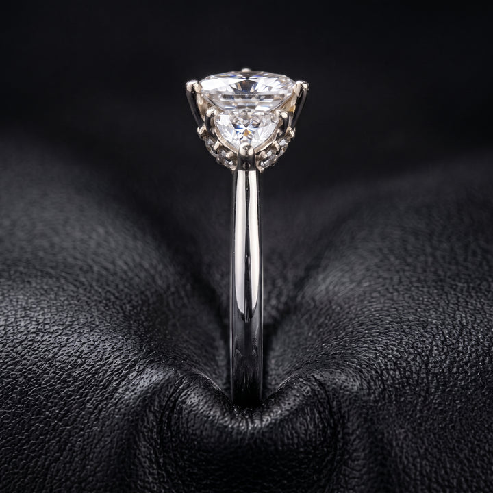 Radiant-cut moissanite ring with trillion side stones set in 14K yellow gold.