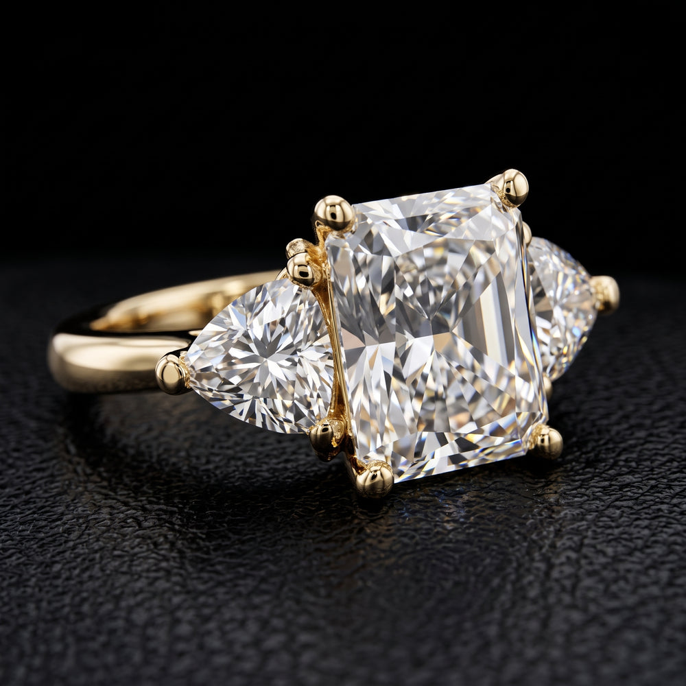 Radiant-cut moissanite ring with trillion side stones set in 14K yellow gold.