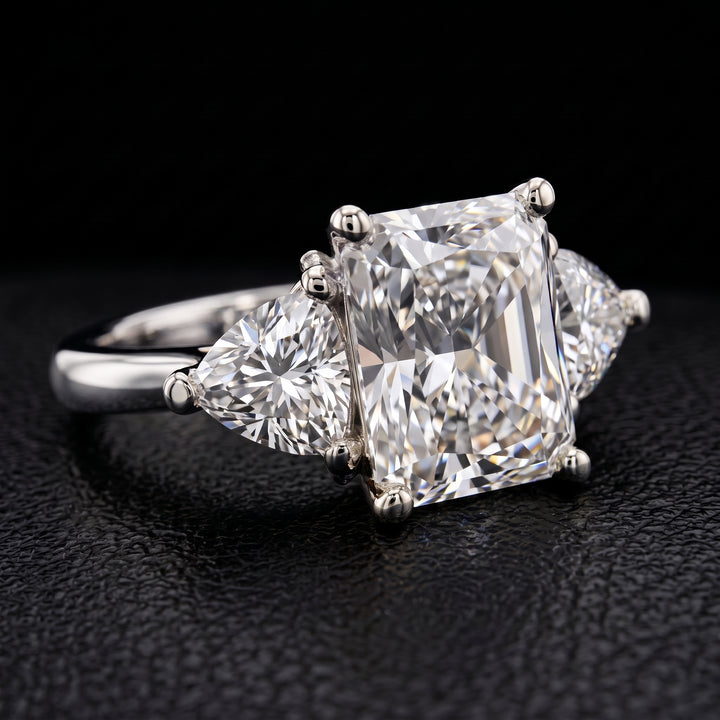 Radiant-cut moissanite ring with trillion side stones set in 14K yellow gold.