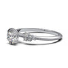 Dainty engagement ring with 0.7 carat round lab-grown diamond in a cluster setting, featuring side diamonds.