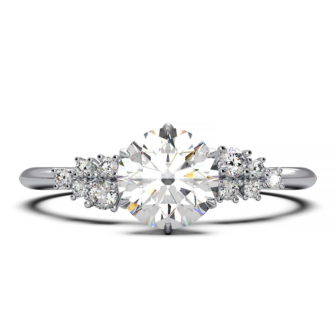 Dainty engagement ring with 0.7 carat round lab-grown diamond in a cluster setting, featuring side diamonds.